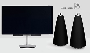 TV on a stand with 2 black speakers