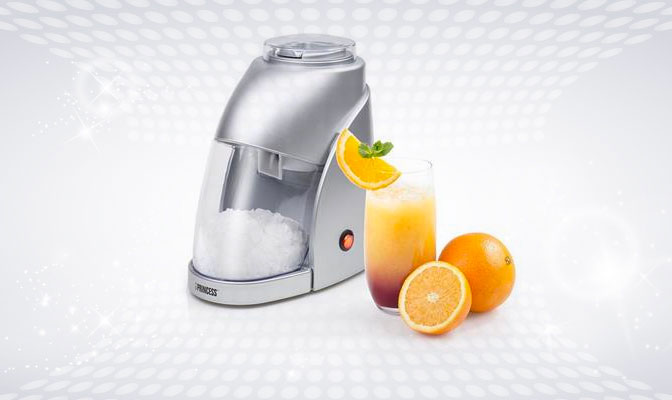 Ice crusher with a glass of orange juice